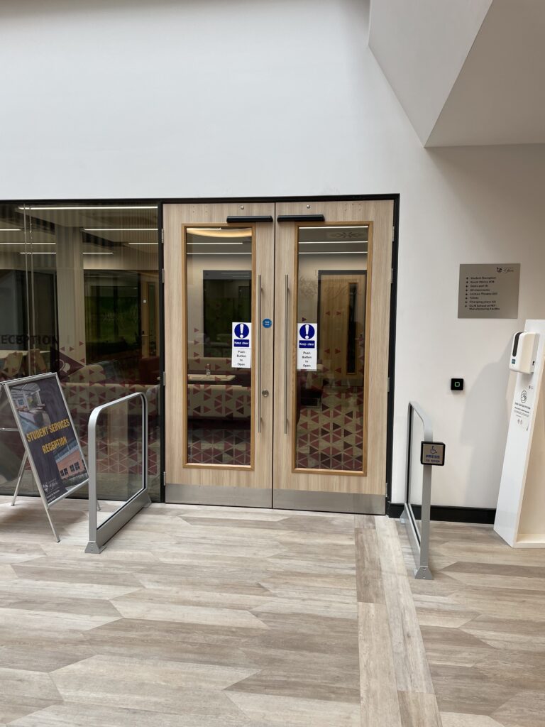 Automatic swing door with motion sensor at office entrance.