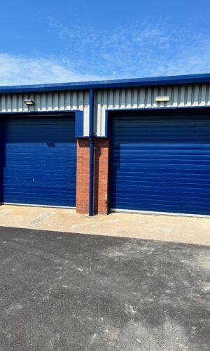 Steel sectional overhead industrial door installed by Northern Door Solutions for warehouse entrance.