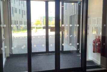 Automatic sliding door installed at commercial facility entrance.